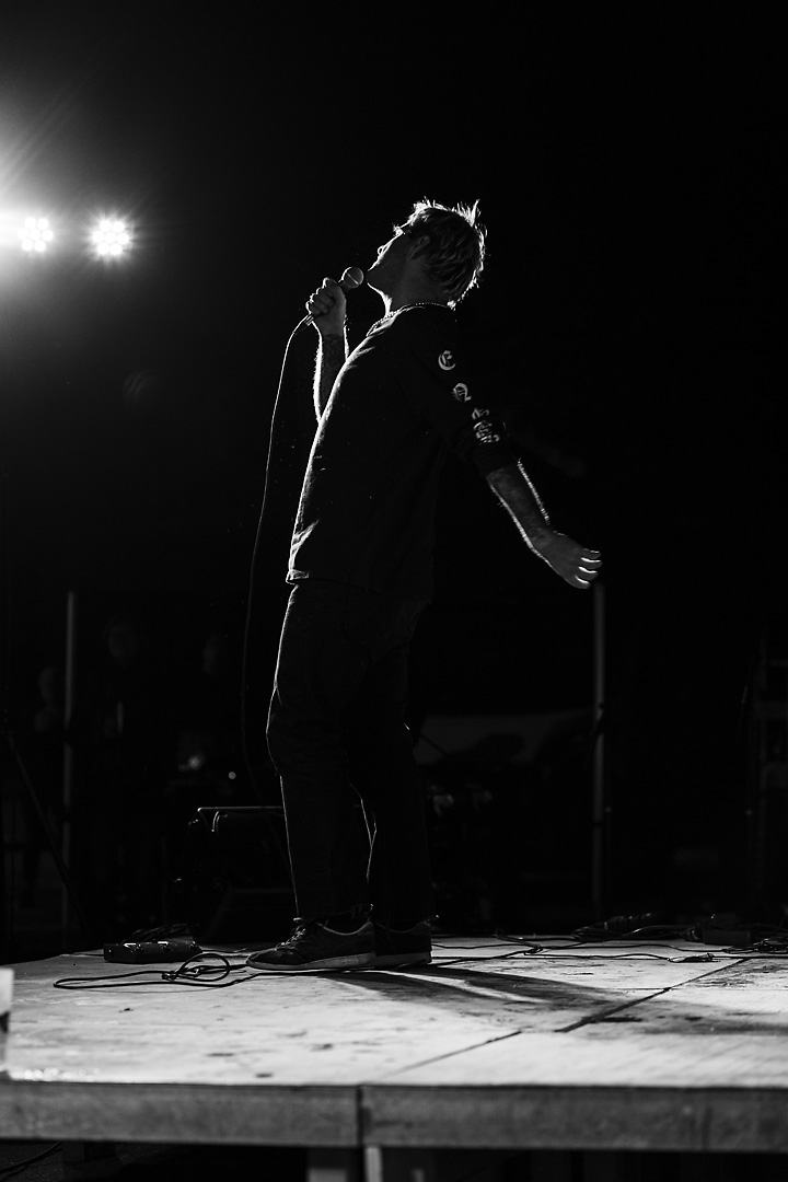 Black-and-white silhouette picture of Salo. He faces the audience as he arches his back.